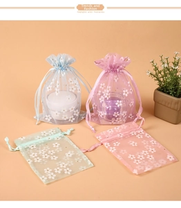 Detail of floral organza drawstring bags in blue, purple, green and pink pastel colors