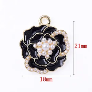 French camellia flower charm with black enamel, pearls, and light gold plating