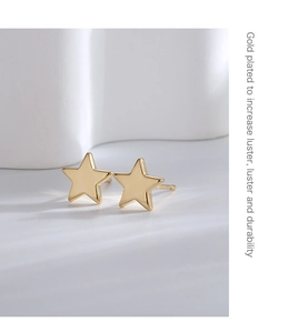 Detailed close-up of gold-plated star studs with text highlighting luster and durability
