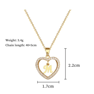 Detail of gold heart pendant with letter M and clear zircons showing size dimensions