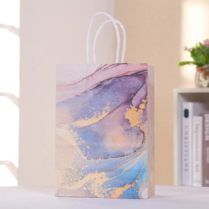 Detail of marble pattern gift bag with blue purple ink textures and golden speckles