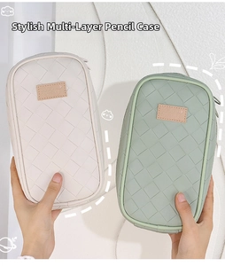 Macro detail of multi-layer woven stationery bag with Good Fortune leather patch label