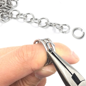 Macro detail of silver jump rings, chain and jewelry pliers for DIY craft making