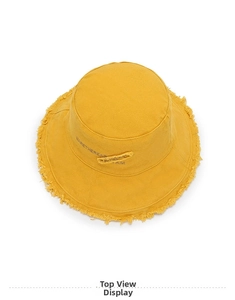 Overhead view of bright yellow canvas bucket hat with frayed edges and embroidery