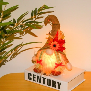 Close-up of glowing Thanksgiving gnome with maple leaf and warm LED light effect