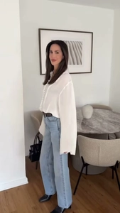 Elegant white shirt with flared sleeves and lace collar paired with blue jeans