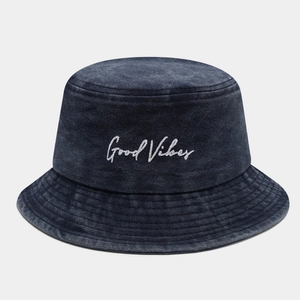 Detail of embroidered Good Vibes text on vintage washed dark blue denim bucket hat