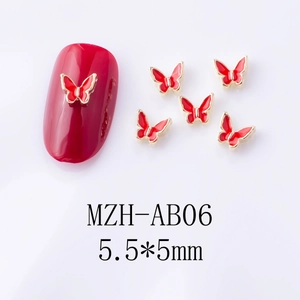 Macro view of 5.5x5mm red alloy butterfly nail charms with golden metal edges