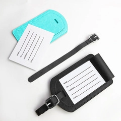 Detail showing blue and black PU leather luggage tags with buckle straps and ID cards