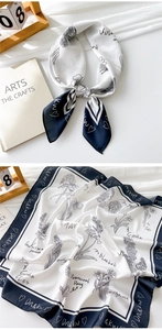 Detail of floral silk scarf with elegant navy blue borders and artistic line drawing