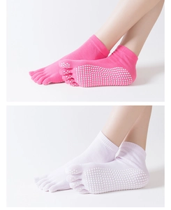 Close-up of pink and white five-finger yoga socks with non-slip silicone grip dots