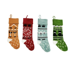 Set of four knitted Christmas pet stockings in red, green, orange, and blue with festive patterns