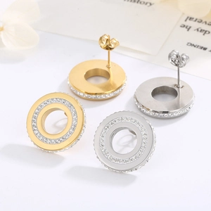 Detail of gold and silver circular earrings with double rows of sparkling crystals