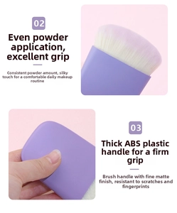 Detail of soft white fiber bristles and purple matte ABS handle of the makeup brush