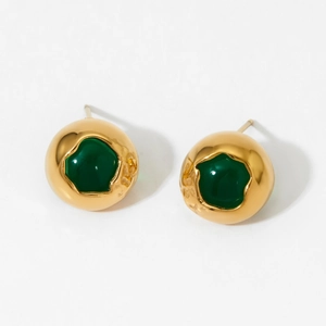 Detailed close-up of gold round stud earrings with irregular green gemstones
