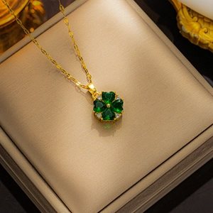 Golden necklace with green heart-shaped gemstones clover pendant and sparkling zircons