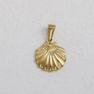 Detail shot of a golden shell-shaped pendant made of high-shine 24K gold-plated stainless steel