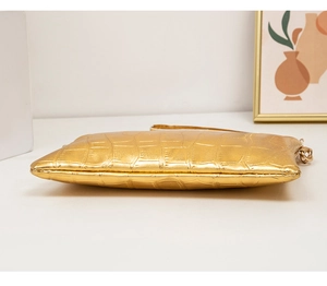 Detail of gold crocodile pattern PU leather bag with metal chain and precise stitching