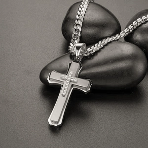 Detail of silver stainless steel multi-layer cross pendant with zircon on cuban chain