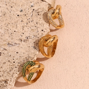 Detail of three interlocking 18K gold plated knot rings with colorful zircon pavé stones
