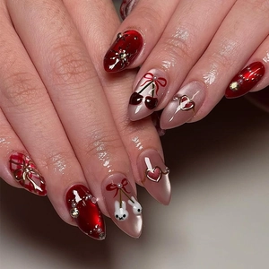 Almond-shaped press-on nails featuring cherry and bunny 3D charms with star patterns