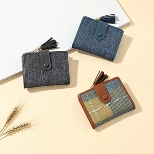 Close-up of minimalist canvas wallets with tassel detail in blue and grey patterns