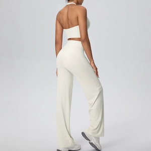 Detail of cream halter yoga set with open back top and high-waist wide-leg pants