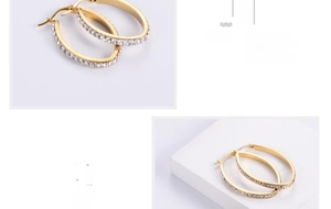 Macro detail of gold oval hoop earrings with sparkling crystal pavé settings