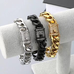Detailed view of silver, black and gold Cuban link bracelets with diamond buckle