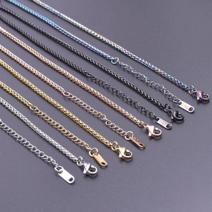 Detail of multi-color stainless steel dragon bone and cross chains with lobster clasps