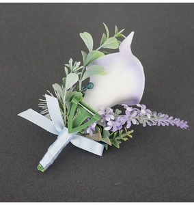Close-up of white and purple calla lily boutonniere with ribbon and safety pin