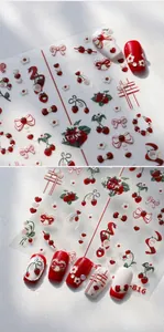 Detail view of 3D embossed nail stickers featuring red strawberries and bow designs