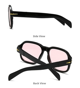 Detail view of square flat top sunglasses with black frames and pink lenses