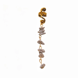 Detail view of gold ear cuff featuring long tassels with irregular grey natural stones