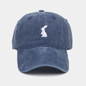 Close-up of white rabbit embroidery on navy washed cotton vintage baseball cap