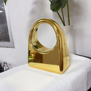Fashionable gold acrylic evening bag with metallic finish and circular handle design