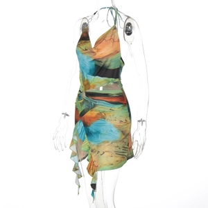 Detail of floral halter dress with deep V-neck, waist cutout, and asymmetric ruffled hem