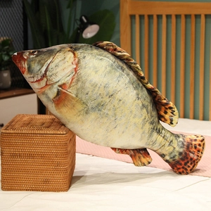 Detailed realistic fish plush pillow showing digital print scales in a cozy home setting