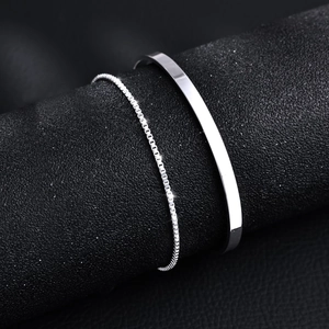 Silver double-layer snake and Cuban chain bracelets on premium black leather