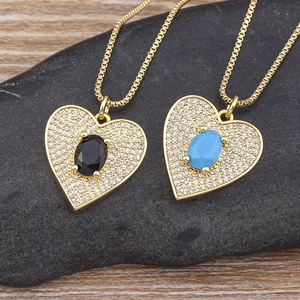 Gold plated heart pendant necklaces with black and turquoise oval stones on stone