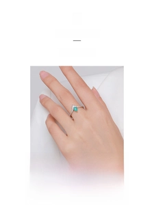 Detailed macro view of pear-shaped green gemstone ring with pavé diamond accents