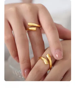 Detail of adjustable golden polished wrap rings showing mirror finish on hand