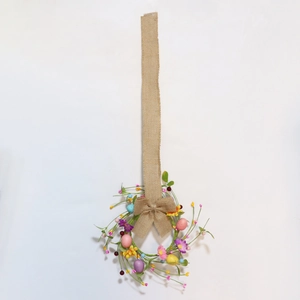 Easter wreath with pastel eggs, daisies, berries and rustic burlap bow on a white background