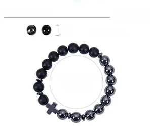 Detail view of 10mm hematite and obsidian beaded bracelet with a black cross charm