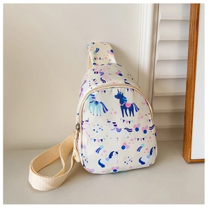 Detailed close-up of a cream kids' chest bag featuring colorful unicorn and rainbow prints
