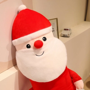 Close-up of plush Santa Claus doll with red pointed hat and soft white beard decor