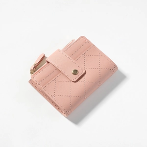 Detail of pink quilted pebble leather wallet showing stitch pattern and golden zipper