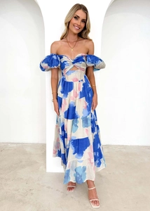 Detail of off-shoulder puff sleeves and waist cutout on abstract print maxi dress