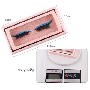 Dramatic thick curled false eyelashes with blue glitter eyeliner effect in a pink box
