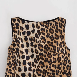 Women's summer A-line dress featuring leopard print and sleek sleeveless boat neckline